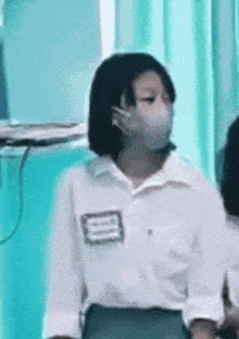 a girl wearing a mask is standing in a room .