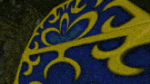 a blue and yellow item with a swirl design