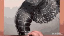 a person is drawing a picture of a spider man costume