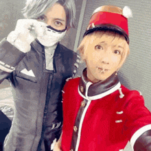 a man in a mask and a man in a red jacket are taking a selfie .