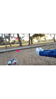 a person is laying on the ground with their feet up and a pink heart in the background