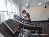 a man is running on a treadmill in a gym sponsored by minimaxel