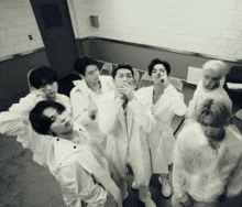 a black and white photo of a group of men in white