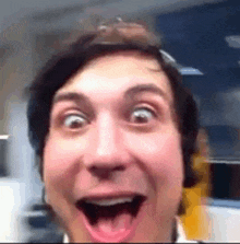 a man is making a funny face with his tongue out .