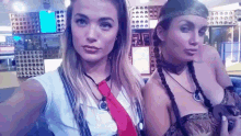 two women are posing for a picture and one is wearing a tie