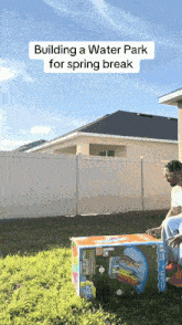 a man sits on a box in the grass with the words building a water park for spring break