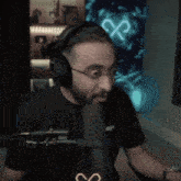 a man wearing headphones stands in front of a microphone