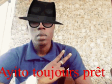 a man wearing a hat and glasses with ayito toujours pret written on the bottom