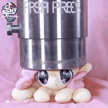 a stuffed animal is sitting in front of a propi press