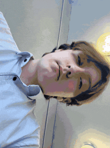 a close up of a person 's face with a light behind them