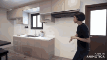 a woman stands in a kitchen with a sign that says cook on it