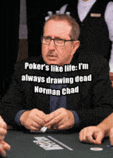 a man with glasses sits at a poker table with a quote from norman chad above him