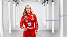 a woman wearing a red racing suit with hp and ibm logos on it
