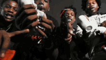 a group of young men are holding up their hands and one of them is wearing a shirt that says ' nc '