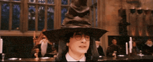 harry potter is wearing a large hat and glasses in a room
