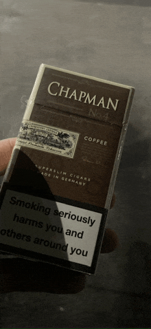 a pack of chapman no 4 coffee cigars being held in someone 's hand