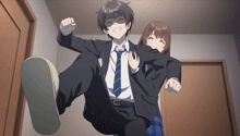a man in a suit and tie is being held up by a girl