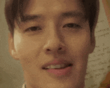 a close up of a young man 's face with his tongue hanging out .