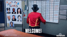 a man in a top hat stands in front of a welcome sign