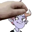 a hand is putting a cartoon character 's head on a table .