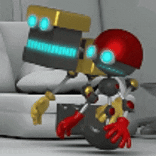 a robot with a red helmet is standing next to a laptop and a briefcase