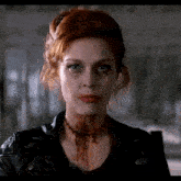 a woman with red hair and blood on her neck