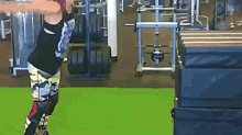 a woman is doing exercises in a gym with a barbell .
