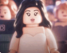 a lego girl in a white dress is standing in front of a crowd .