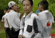a group of men standing in a line with cnn written on the back of their shirts