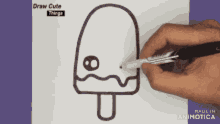 a person is drawing an ice cream with a feather in it