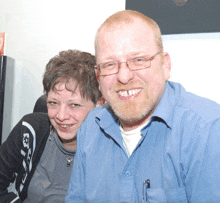 a man and a woman are smiling for the camera
