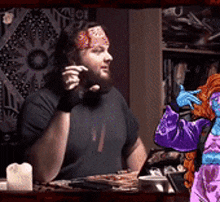 a man with a bandana on his head is sitting at a table