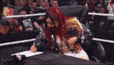 a woman in a wrestling ring is signing a piece of paper