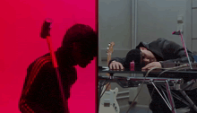 a man laying on a table next to a microphone and another man playing a guitar