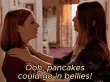 two women looking at each other with the words ooh pancakes could go in bellies below them