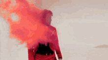 a man in a red jacket with an x on the front is surrounded by red smoke