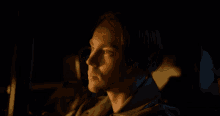 a man is sitting in the back seat of a car with his eyes closed