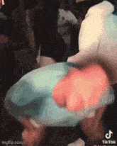 a person is holding a piece of paper in their hand in a crowd .