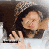 a woman wearing a leopard print hat says bye to blink 's too