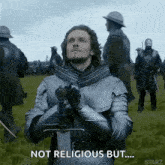 a man in armor is holding a sword in a field and saying `` not religious but ... ''