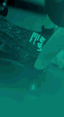 a person lifting a dumbbell in a gym with a shirt that says fly on it