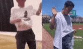 a man wearing a white shirt that says eddom is dancing on a baseball field