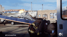 a group of firefighters standing next to an ambulance with the hashtag #chicagofire on the bottom