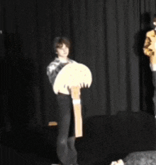 a man and a woman are standing on a stage holding a sign that says ' a ' on it