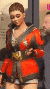 a woman in a red jacket and shorts is standing next to a man .