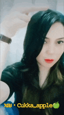 a woman is taking a selfie with the words cuka apple on the bottom