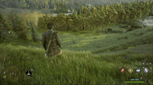 a video game shows a man standing on a hill looking at a lake