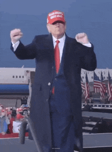 donald trump is wearing a red white and blue hat that says make america great again
