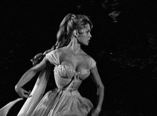 a woman in a long white dress is running in the dark