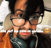 a man wearing glasses and headphones with the caption she put me nam in yelow